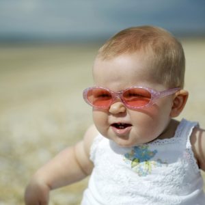 Hot baby on the beach who is happy to hear about the Haly air conditioner sale. 